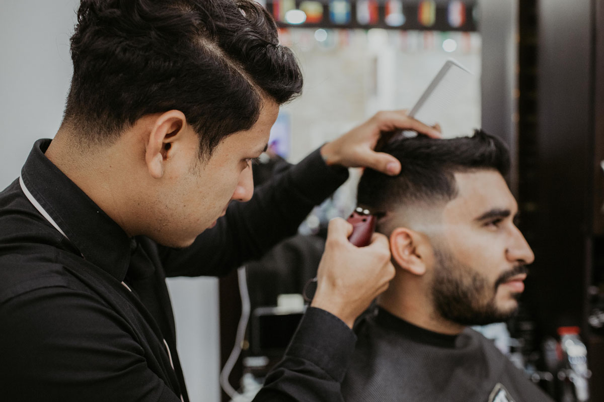 hairstylist cutting man's hair at the salon