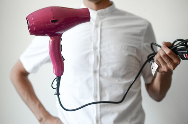 person holding hair blower